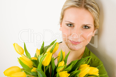 Young woman hold yellow tulips flower