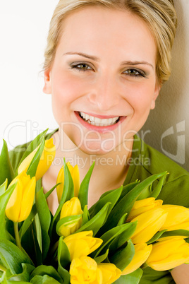 Young woman hold yellow tulips flower