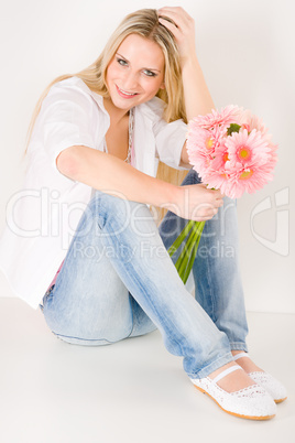 Young woman hold pink gerbera daisy flower