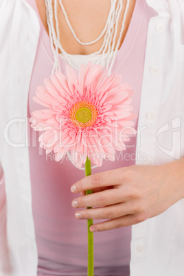 Gerbera pink daisy flower hold by woman