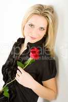 Elegant blond woman hold red rose