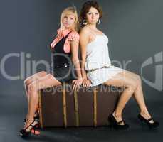 Two beautiful girls with suitcase