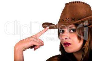 Sexy young cowgirl tapping her hat