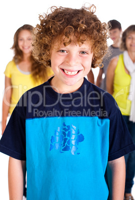 Smiling kid in focus with family posing in the background