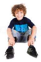 Adorable young kid sitting on floor