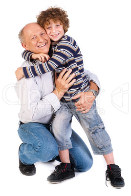 Grandson hugging his grandpa, indoors