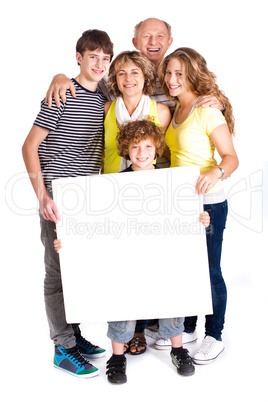 Portrait of a happy family holding a billboard