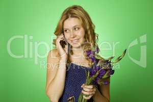Woman on the phone and holds a bouquet of flowers