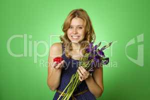 Attractive girl holding flowers and a gift box