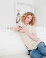 Attractive blonde female enjoying a cup of coffee while sitting
