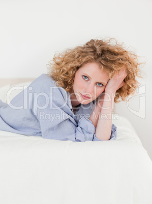 Charming blonde woman posing while lying on her bed Charming blonde woman posing while lying on her bed