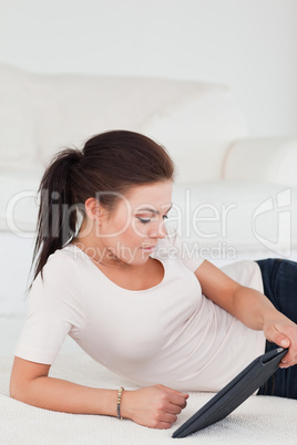 Cute dark-haired woman using a tablet Cute dark-haired woman using a tablet