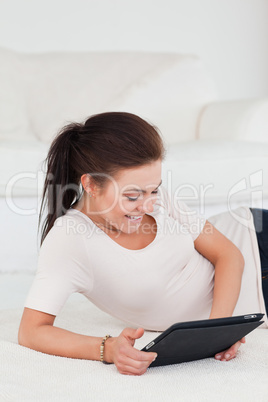 Smiling dark-haired woman using a tablet Smiling dark-haired woman using a tablet