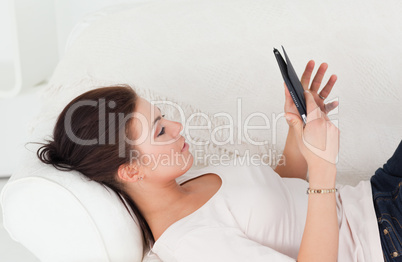 Smiling brunette using a tablet