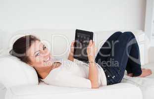 Woman using a tablet while looking at the camera