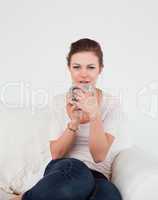 Portrait of a cute brunette enjoying a cup of tea
