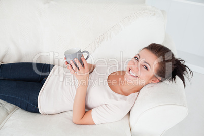 Young brunette enjoying a cup of tea