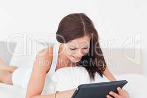 Smiling young woman with a tablet