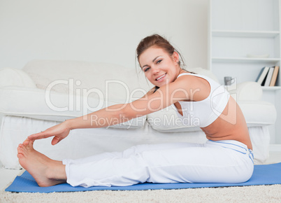 Happy brunette practicing yoga