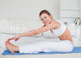 Happy brunette practicing yoga