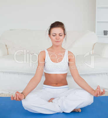 Calm brunette practicing yoga