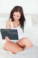 Smiling brunette with a tablet