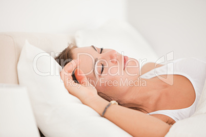 Brunette sleeping in her bed