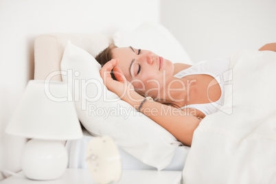 Young brunette sleeping in her bed
