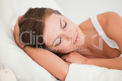 Young woman sleeping in her bed
