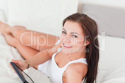 Close up of a cute brunette with a tablet