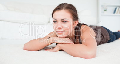 Young woman liying on a carpet