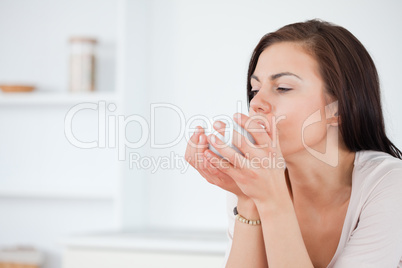 Close up of a brunette having a coffee