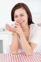 Portrait of a brunette enjoying a coffee