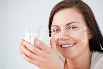 Close up of a beautiful brunette enjoying a coffee