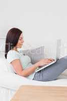 Beautiful woman typing on her laptop