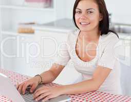 Close up of a smiling woman with a laptop