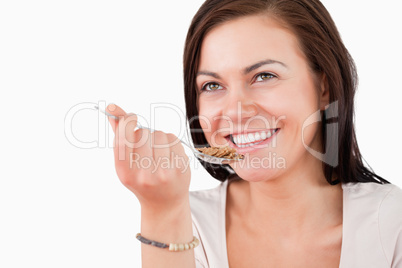 Close up of a charming woman eating cereal