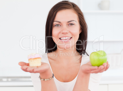 Young woman with an apple and a piece of cake