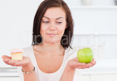 Cute woman with an apple and a piece of cake