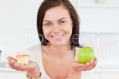 Close up of a cute woman with an apple and a piece of cake