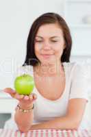 Smiling woman showing an apple