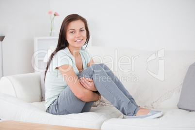 Close up of a young woman posing on her sofa