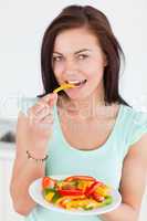 Beautiful woman eating a salad