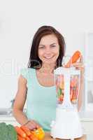 Young woman using a blender