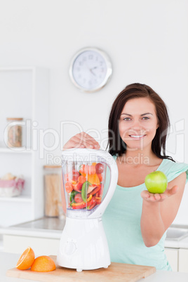 Woman with a blender and an apple