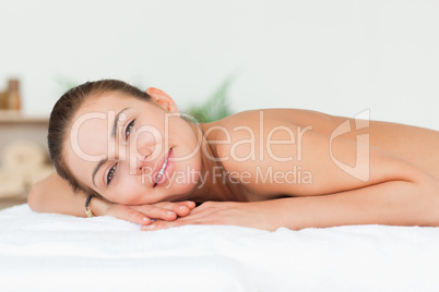 Woman lying on her belly looking at the camera