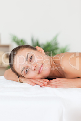 Portrait of a woman lying on her belly looking at the camera