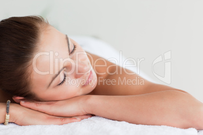 Close up of a young brunette lying on a massage table