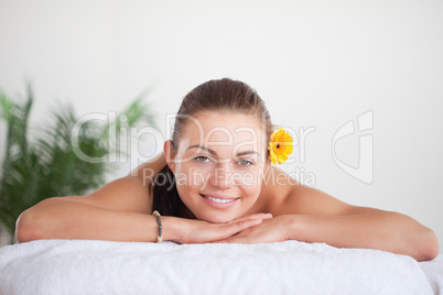 Smiling brunette with a flower on her ear