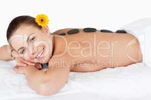 Smiling woman having a hot stone massage